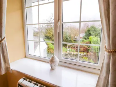 a window with a vase sitting on a window sill at Maiden Moor in Keswick