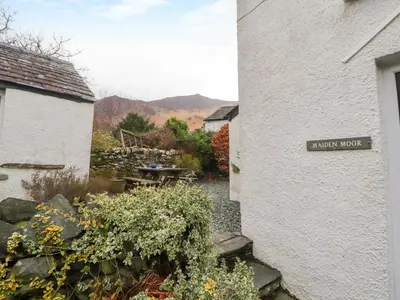 a sign for a garden next to a white building at Maiden Moor in Keswick