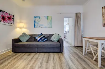 a living room with a couch and a table at Apartment Caerlaverock Road in Prestwick