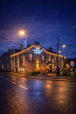 a building with a sign on it on a street at The Cassillis Hotel - Smart Self Check-in Hotel & Bar in Maybole