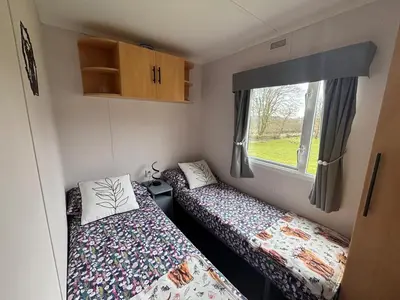 a small room with two beds and a window at No 38 Heilan Hoose at Three Lochs Newton Stewart in Newton Stewart