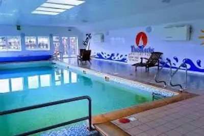 a large swimming pool in a building at No 38 Heilan Hoose at Three Lochs Newton Stewart in Newton Stewart