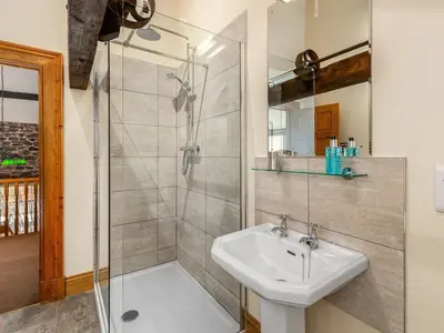 a bathroom with a sink and a shower at Barley Store - Uk48910 in Allonby