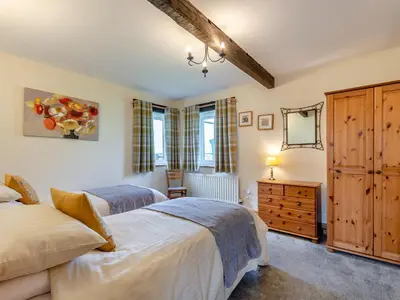 a bedroom with two beds and a dresser at Milking Parlour - Uk48911 in Allonby