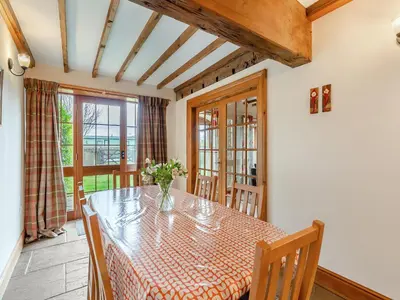 a dining room with a table and chairs and a window at Engine House - Uk48912 in Allonby