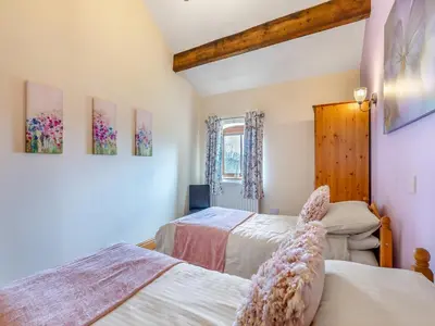 a bedroom with two beds and a window at Engine House - Uk48912 in Allonby