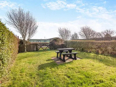 a picnic table in the grass in a field at Engine House - Uk48912 in Allonby