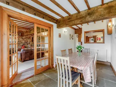 a kitchen and dining room with a table and chairs at Engine House - Uk48912 in Allonby
