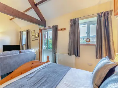 a bedroom with a bed and a window at Eight Byre - Uk48913 in Allonby