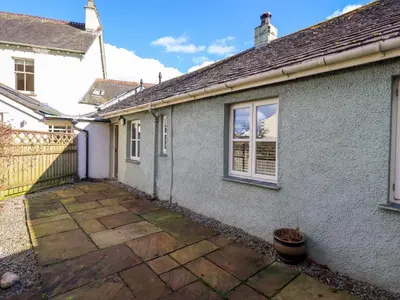 a house with a patio in front of it at Fox Howe in Keswick