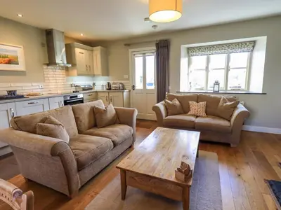 a living room with two couches and a coffee table at Fox Howe in Keswick