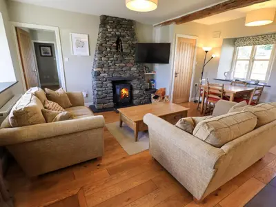 a living room with two couches and a fireplace at Fox Howe in Keswick