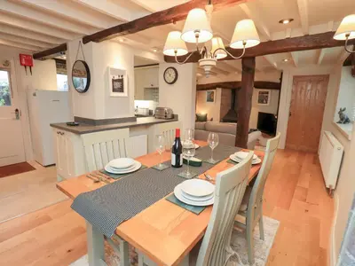 a kitchen and dining room with a table and chairs at Jasmine Cottage in Keswick