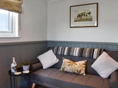 a couch with pillows on it in a room at Meadows View Shepherd's Hut in Cockermouth