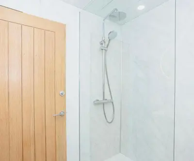 a shower in a bathroom with a glass door at Caul View Apartment in Dumfries
