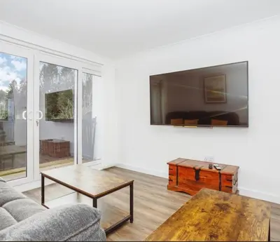 a living room with a couch and a coffee table at Caul View Apartment in Dumfries