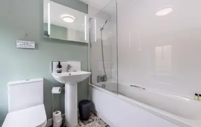 a bathroom with a sink and a toilet and a shower at King George IV Inn in Eskdale