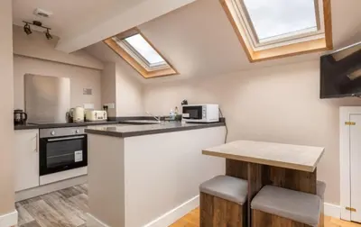 a kitchen with a counter and some skylights at King George IV Inn in Eskdale