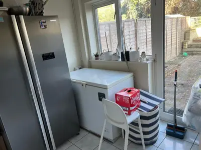 a kitchen with a refrigerator and a table and a chair at IFYLOVESITt2 in Moffat