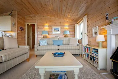 a living room with a couch and a table at The Buoys in Girthon