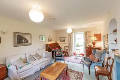 a living room with a couch and a table at The Miller's House in Castle Douglas