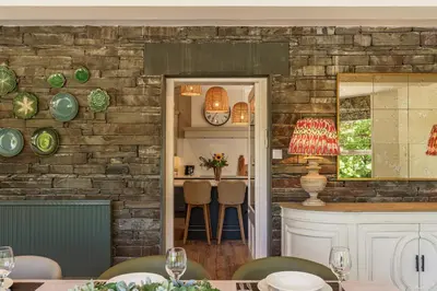 a kitchen and dining room with a brick wall at Leathes Head Country House in Keswick