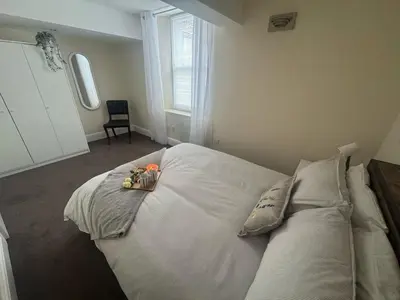 a bedroom with a large bed with two pillows at The Hidden Hicks - Sleeps 2 in Whitehaven
