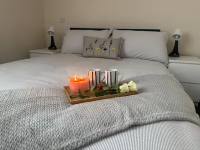 a tray with a candle on a bed at The Hidden Hicks - Sleeps 2 in Whitehaven