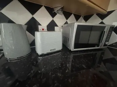 two microwaves and a microwave on a counter at The Hidden Hicks - Sleeps 2 in Whitehaven