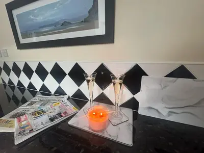 a table with scissors and a candle and newspapers at The Hidden Hicks - Sleeps 2 in Whitehaven