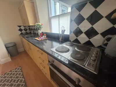 a kitchen with a stove and a counter top at The Hidden Hicks - Sleeps 2 in Whitehaven