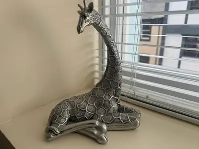 a metal giraffe statue sitting on a window sill at Hicks Central - Sleeps 2 in Whitehaven