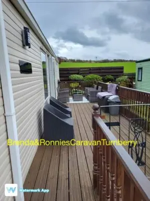 a wooden deck with chairs on a house at B&R 18 Gleneagles in Turnberry