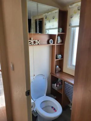 a bathroom with a white toilet in a room at B&R 18 Gleneagles in Turnberry