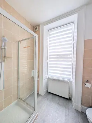 a bathroom with a shower and a glass shower stall at Kings House in Douglas