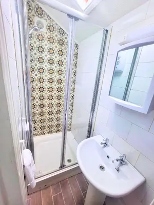 a bathroom with a sink and a shower at Kings House in Douglas