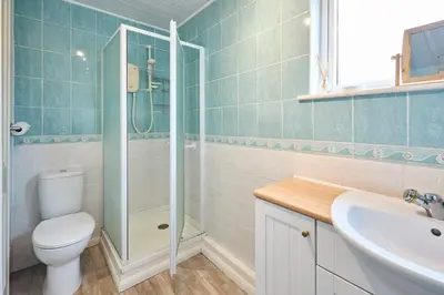 a bathroom with a shower and a toilet and a sink at Host & Stay - Trinity Way in Keswick