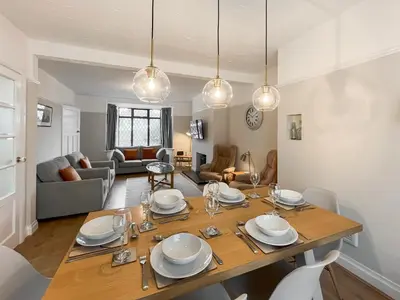 a dining room and living room with a table and chairs at Hindsgarth in Keswick
