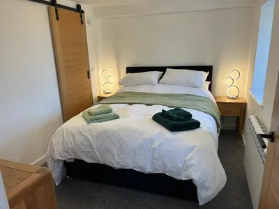 a bedroom with a bed with two towels on it at Oystercatcher in Dalby