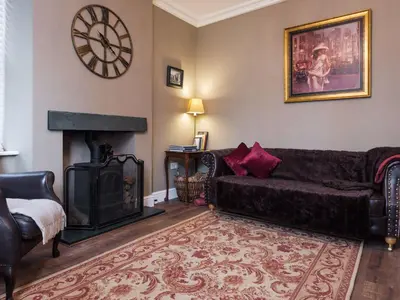 a living room with a couch and a fireplace at Skyfell House in Keswick