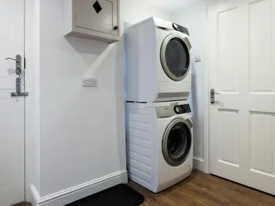 a washing machine and a dryer in a room at Skyfell House in Keswick