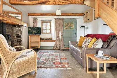 a living room with a couch and a table at Finest Retreats - St Francis Cottage in Ulpha