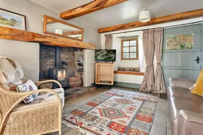 a living room with a couch and a fireplace at Finest Retreats - St Francis Cottage in Ulpha