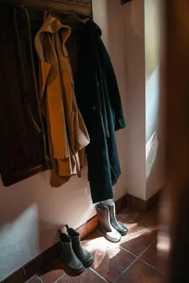 a group of coats and boots are hanging on a closet at Riverside Country House and Cottage in Sunderland
