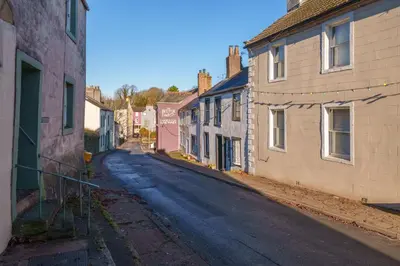 an empty street in a small town with buildings at Bell Cottage - Cockermouth is five minutes walk to pubs, restaurants and shops in Cockermouth