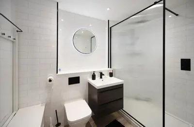 a bathroom with a toilet and a sink and a shower at Barassie Bay View apartment in Troon