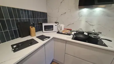 a kitchen with a stove and a microwave on a counter at 5 Bedrooms Sleeps 10 Full Kitchen Parking in Ayr