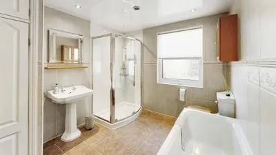 a bathroom with a shower and a sink and a toilet at Stanley House in Bassenthwaite