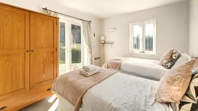 a bedroom with two beds and a large window at Skiddaw Heights in Keswick