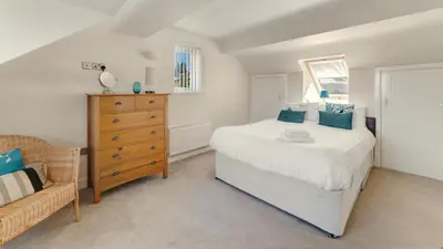 a bedroom with a bed and a wooden dresser at Skiddaw Heights in Keswick